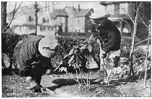 photo of two little girls gardening