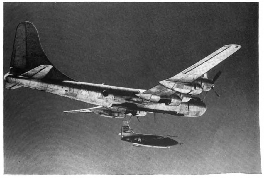 A small airplane being released from a larger mother-plane