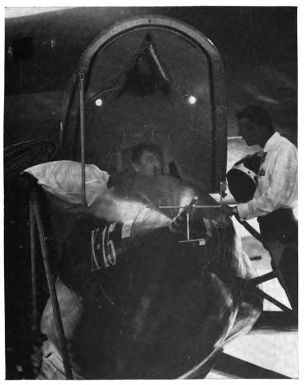 picture of a man in a cockpit and another man alongside holding a helmet