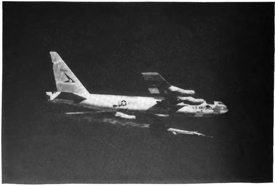 A plane in the air with a small plane directly underneath it