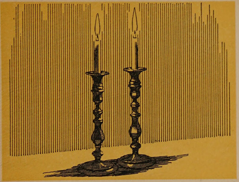 Two lit candles in tall candlesticks
