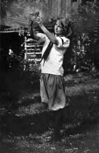 The Country Girl and Her Pets. "The quietness of the
country permits a greater spiritual and mental growth, with its
abundance of life, plant and animal, which challenges the mind to
discover its secrets."