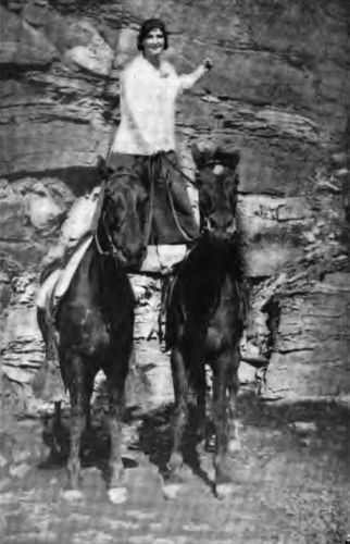 This photograph of a Camp Fire Girl shows the opportunity
country life affords for good sport.