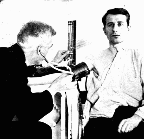 Fig. 25.&mdash;Observation by the auscultatory method and a mercury instrument. One hand
regulates the stop cock which releases air gradually.