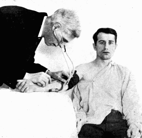 Fig. 26.&mdash;Observation by the auscultatory method and a dial instrument. The right
hand holds the bulb and regulates the air valve.