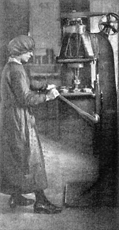 A Woman
    Operating a Multiple Spindle Drill in an English Shell Factory.
